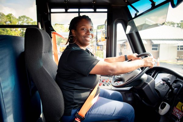 a st johns county bus driver sits in the drivers seat