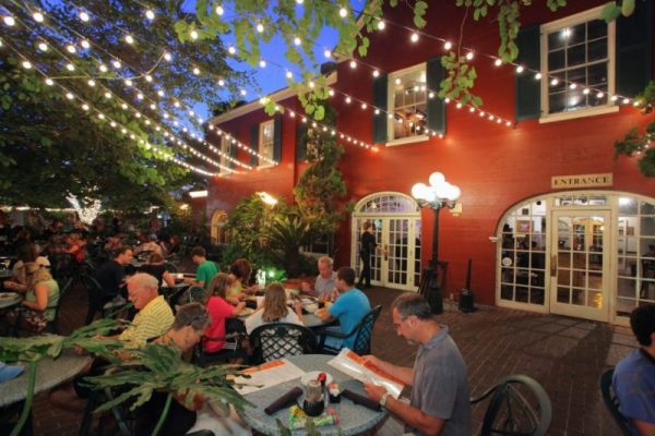 Guests at Harry's Seafood Bar & Grill in St. Augustine enjoy dinner on the outdoor patio under lights.