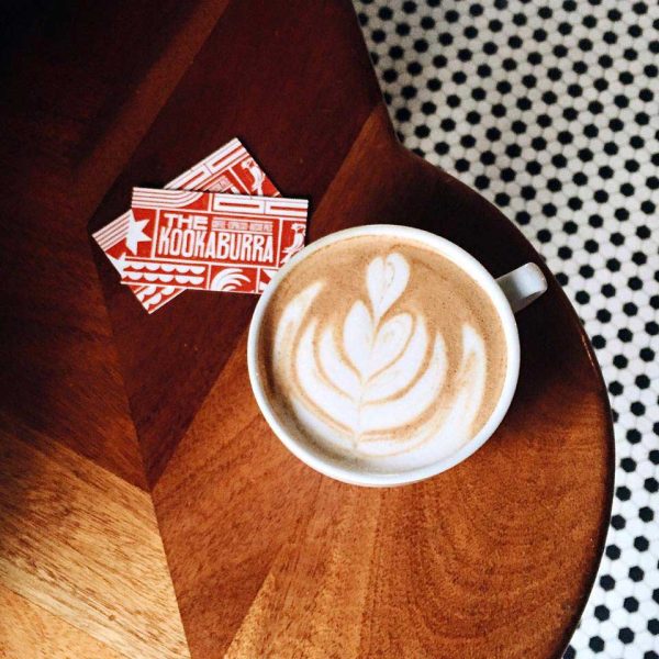 kookaburra coffee latte sitting on a wooden table