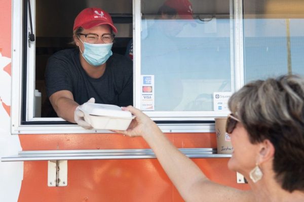 Safely servinig delicious meals at the Fried Chicken Kitchen Food Truck